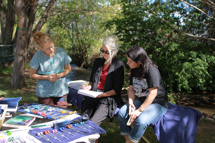 Sound healing instructor and students in outdoor class setting
